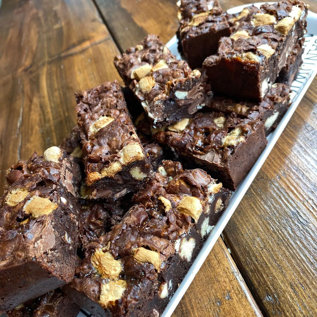 Chunky rocky road brownies piled on a board