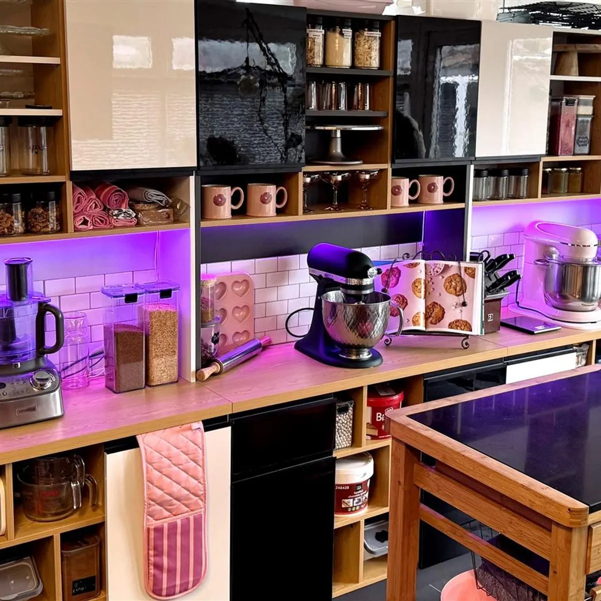 Tracy's home bakery kitchen with stand mixers, jars of ingredients and pink lighting